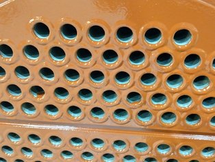 Detailed view on a Carbon steel tube sheet of an alloy tube bundle coated with Si 57 E baked epoxy-phenolic lining