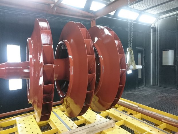 Three Impeller Wheels mounted on a shaft, coated with Si 57 E, during application of the coating